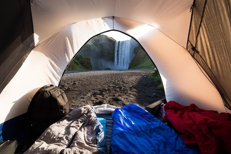 Tent with an opened side looking at waterfalls.