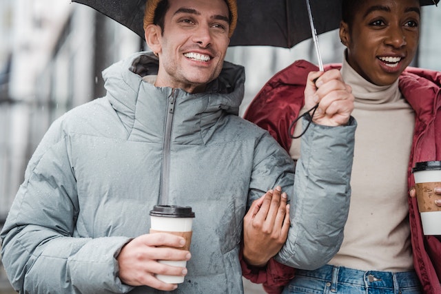 couple walking with an umbrella on a rainy day 